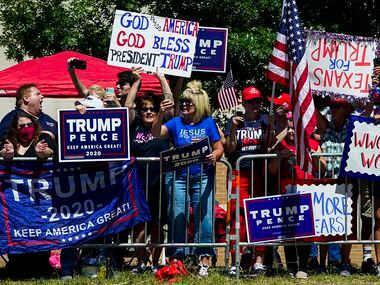 Supporters gather on the road near the church as President Donald TrumpÕs motorcade moves...