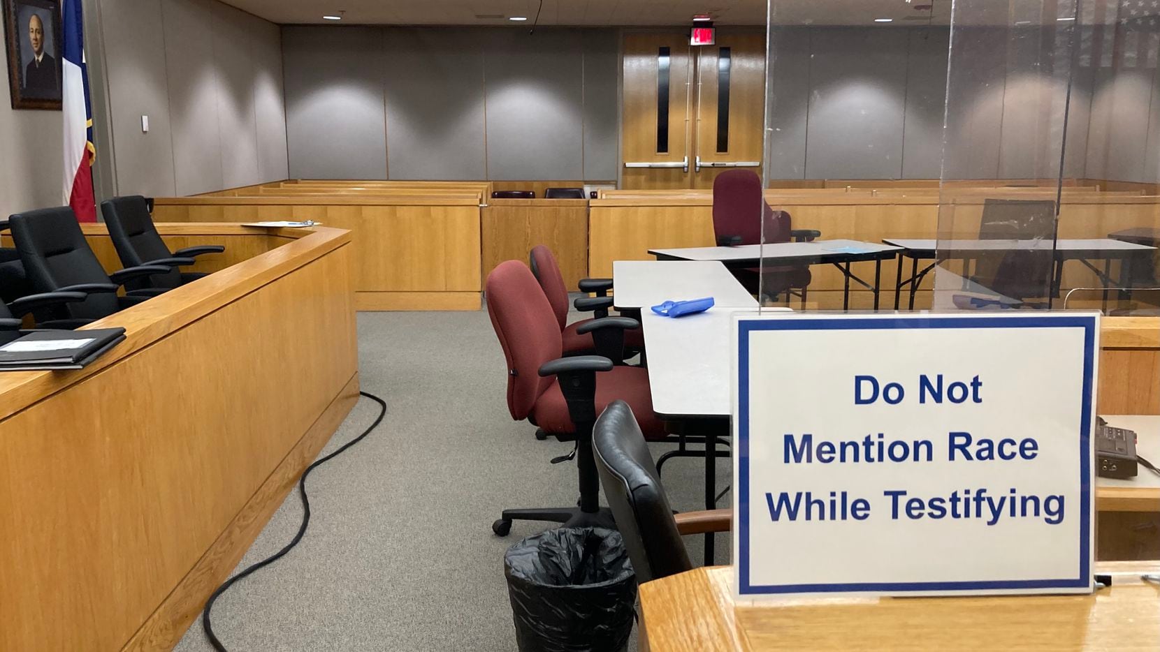 A sign prohibiting discussions of race is posted inside grand jury room witness boxes.