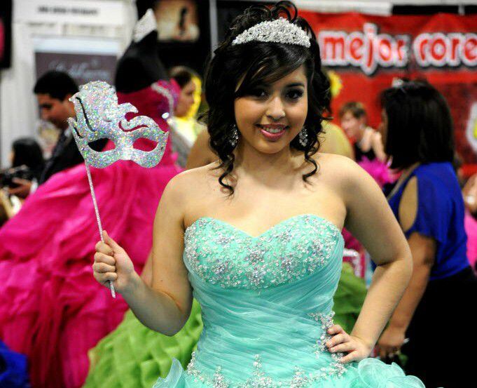 Alexis Ortiz models a sea foam colored dress at the Latino Bridal and Quince Girl Expo.