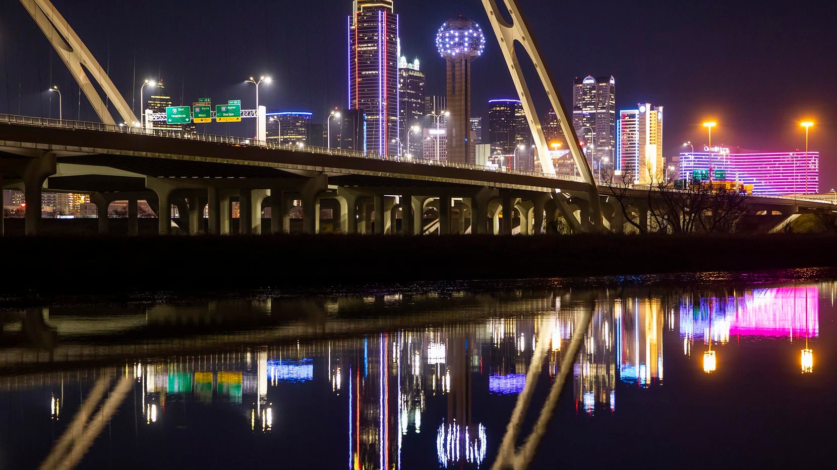 The downtown Dallas skyline is seen behind the Margaret McDermott Bridge lit in Southwest...
