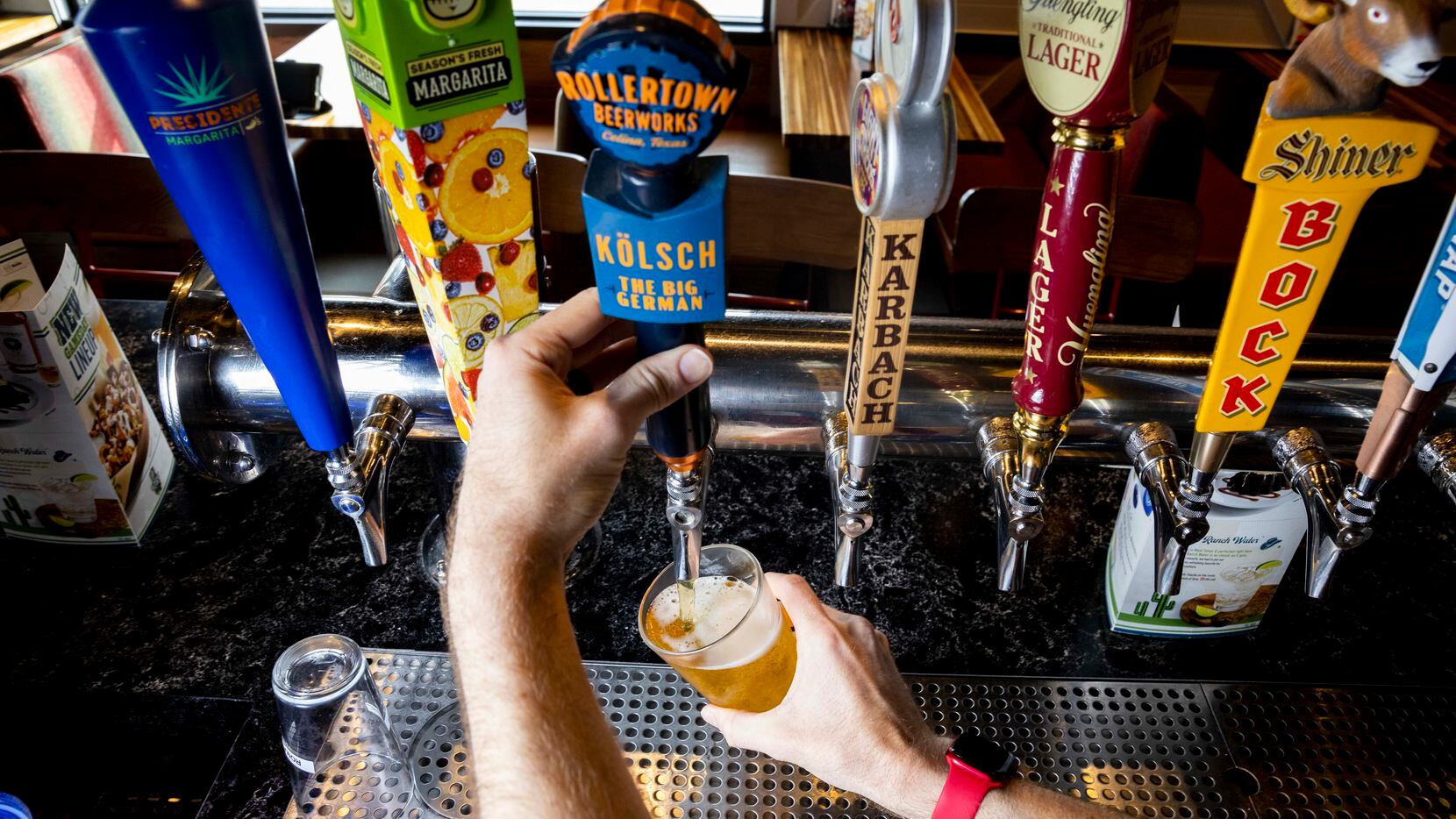 Bartender Greg Miller pours a glass of Rollertown Beerworks’ new kolsch beer at Chili's in...
