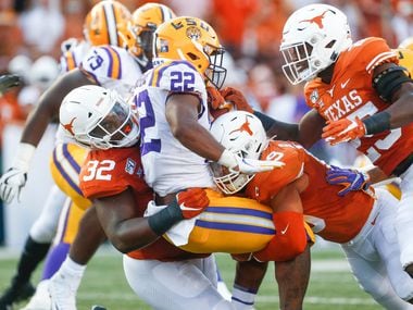 Texas Longhorns defensive lineman Malcolm Roach (32) and defensive back Brandon Jones (19) put a stop to LSU Tigers running back Clyde Edwards-Helaire (22) during the first quarter of a college football game between the University of Texas and Louisiana State University on Saturday, Sept. 7, 2019 at Darrell Royal Memorial Stadium in Austin, Texas. (Ryan Michalesko/The Dallas Morning News)