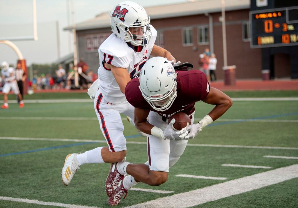 Lewisville junior wide receiver Isiah Stevens (5) gets a foot down before he is driven out...