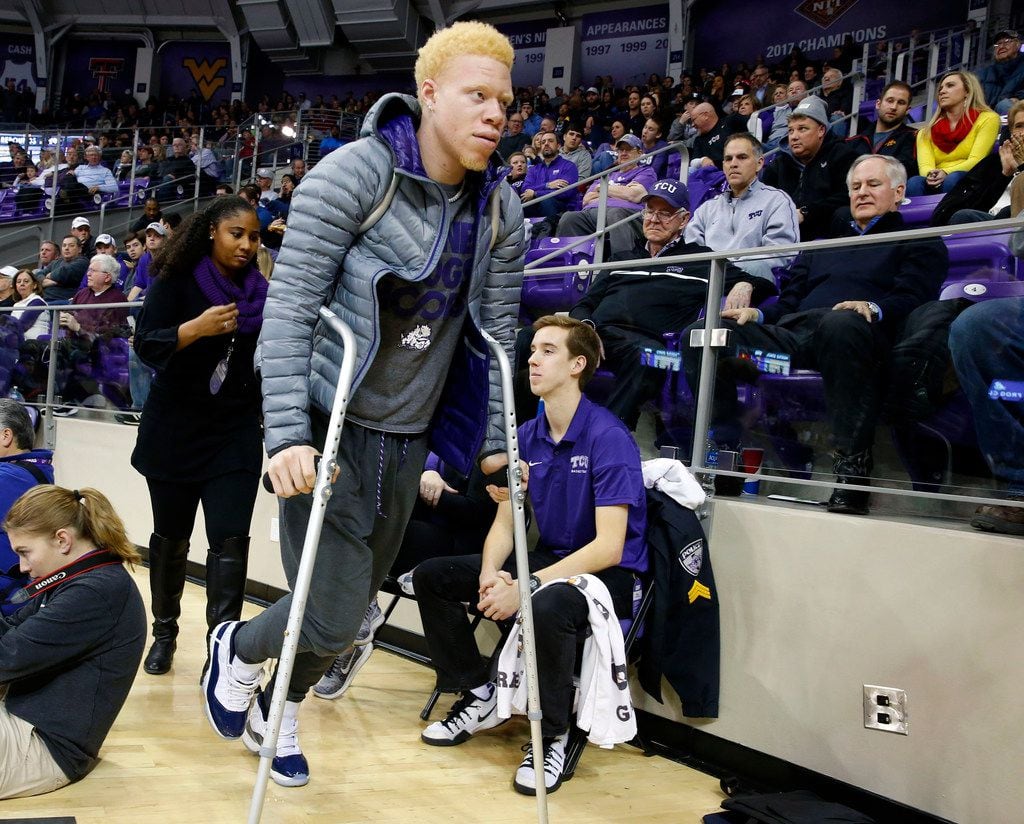 Texas Christian's Jaylen Fisher walks with the help of crutches as he leaves the arena after...