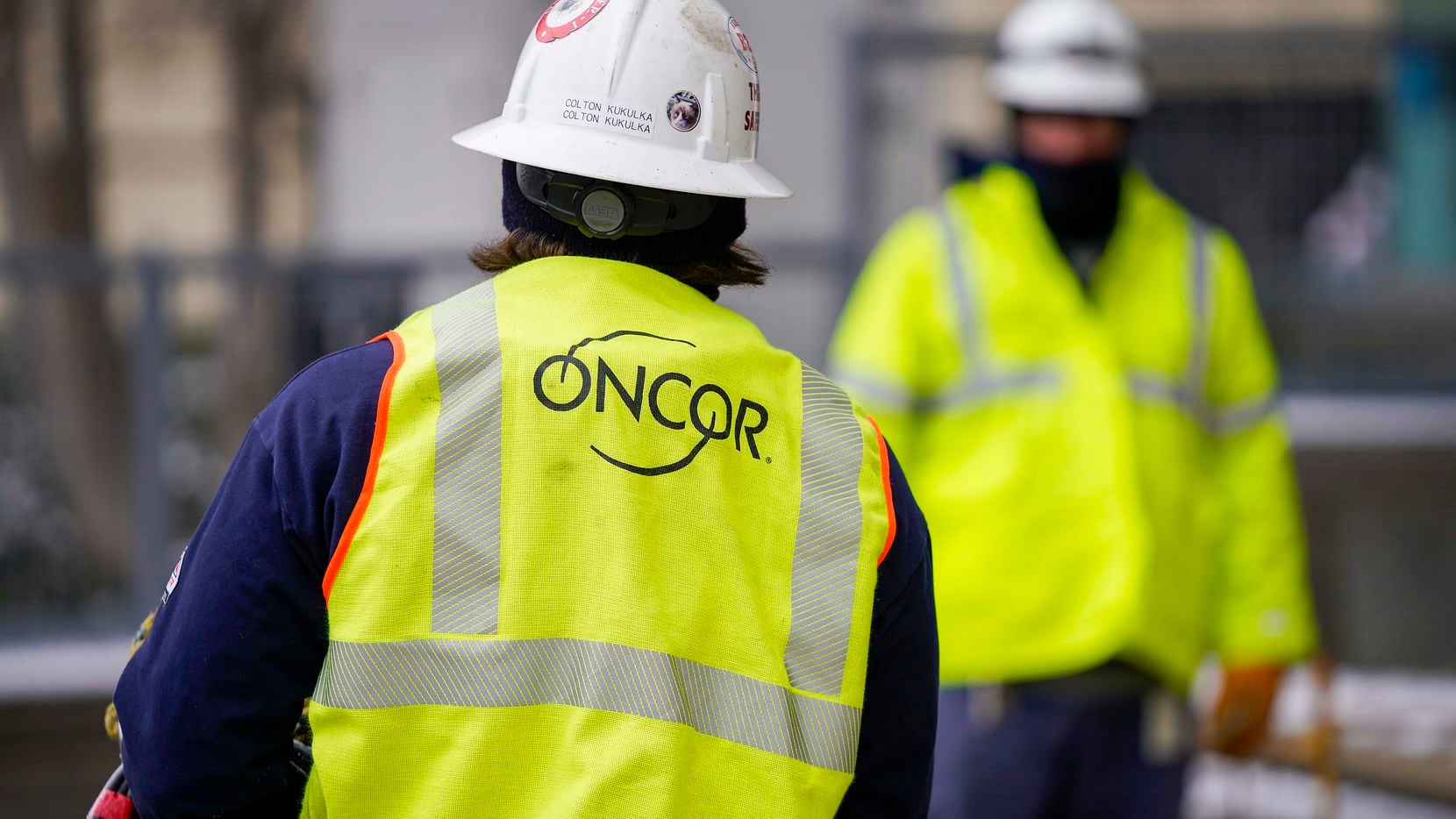 An Oncor works outside a downtown building after a winter storm brought snow and freezing...
