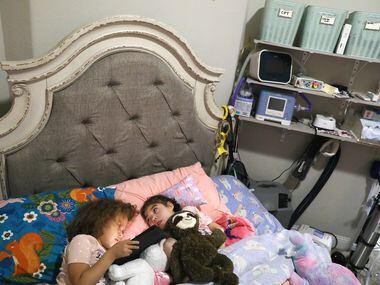 Lincoln Brooks, 4, watches a show with older sister Charlotte Brooks, 5, at their home in...