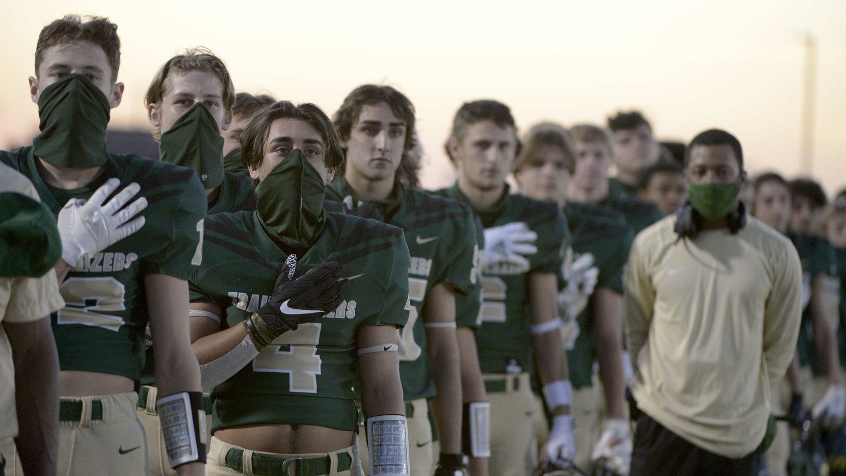 Lebanon Trail football players during the National Anthem before a high school football game...