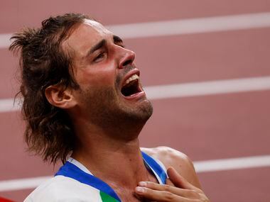 Italy’s Gianmarco Tamberi gets emotional after winning a gold medal in the men’s high jump...