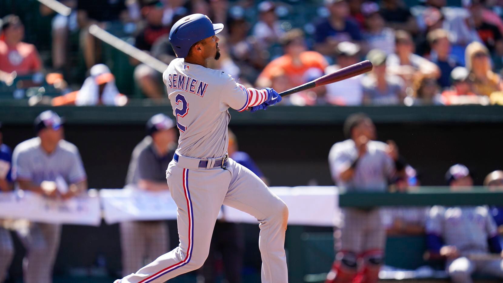 Texas Rangers' Marcus Semien watches his ball while hitting a solo home run against the...