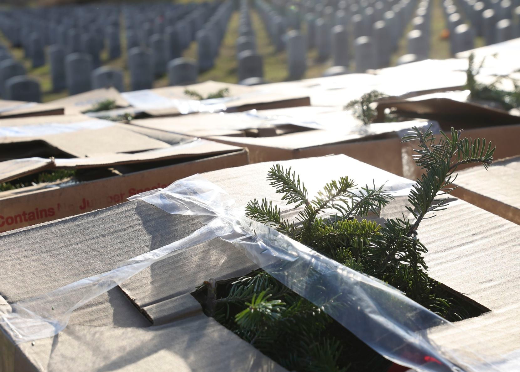 Boxes of wreaths sit at Dallas-Fort Worth National Cemetery Friday, Dec. 16, 2022, in...