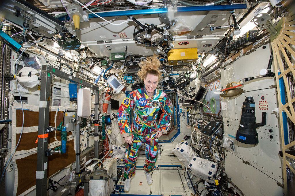 Astronaut Kate Rubins floats aboard the International Space Station wearing a hand-painted...