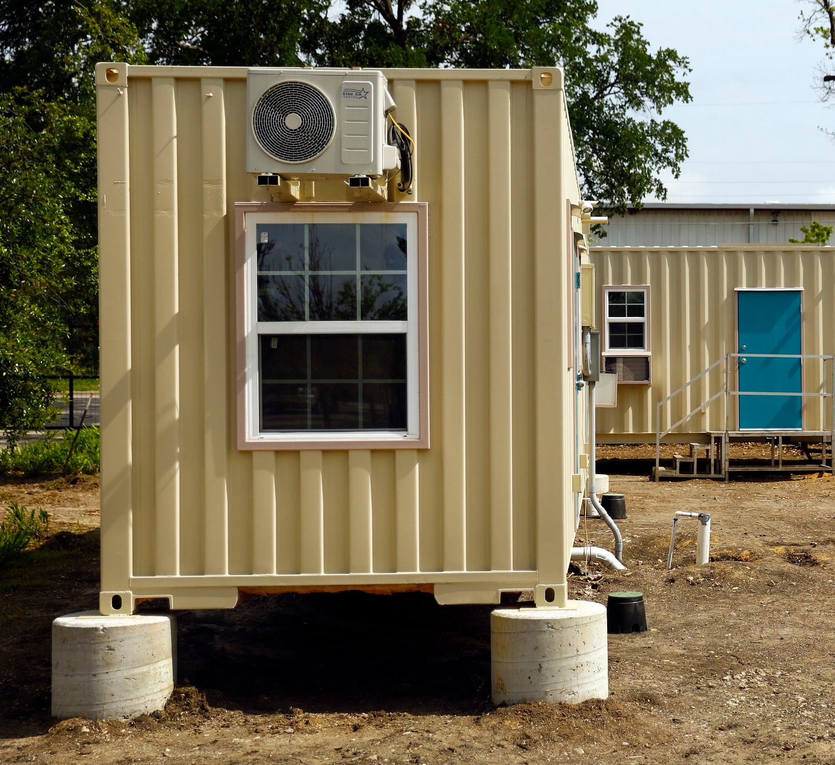 A pair of new experimental structures fabricated from recycled shipping containers are being finished out at The Cottages at Hickory Crossing. One of the 40-foot-long containers (left) houses two studio units, and the other has 

a single, one-bedroom apartment.