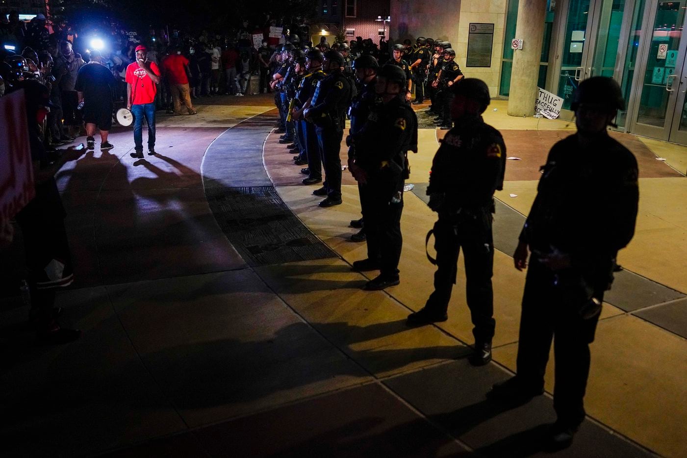 Dallas police form a line outside the front door of the the Dallas Police Headquarters as...