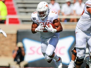 Running back Bijan Robinson #5 of the Texas Longhorns runs the ball during the first half of the college football game against the Texas Tech Red Raiders on September 26, 2020 at Jones AT&T Stadium in Lubbock, Texas.