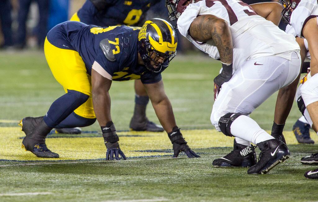 Michigan defensive lineman Maurice Hurst (73) gets into his stance at the line of scrimmage...