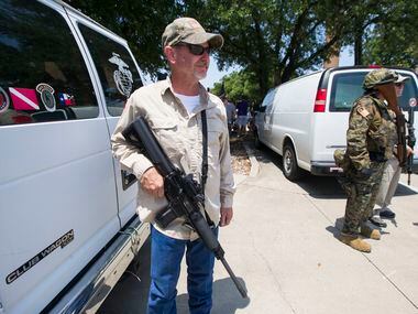 Anti-Shariah protester Jim Rodgers of Fort Worth holds his gun during an anti-Shariah...