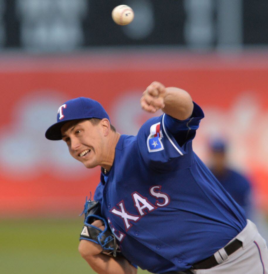 Texas Rangers pitcher Derek Holland works in the fourth inning against the Oakland Athletics...