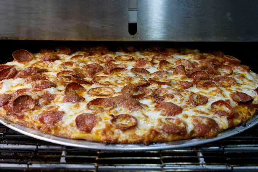 A triple pepperoni pizza comes out of the oven at Old Hag’s Pizza and Pasta in Lewisville.