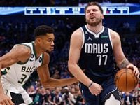 Dallas Mavericks guard Luka Doncic (77) reacts after being hit in the groin by Milwaukee...