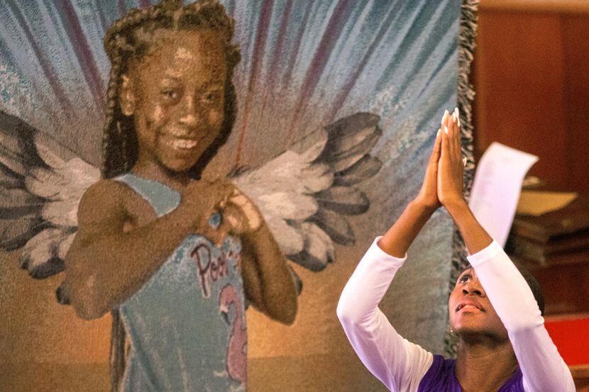 Cierra Cotton performs a praise dance during the funeral for 9-year-old Brandoniya Bennett...