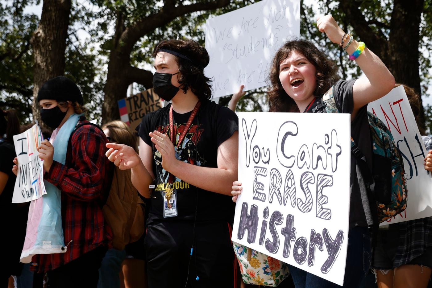 Grapevine High School student Ozz Anderson, right, reacts alongside other students during a...