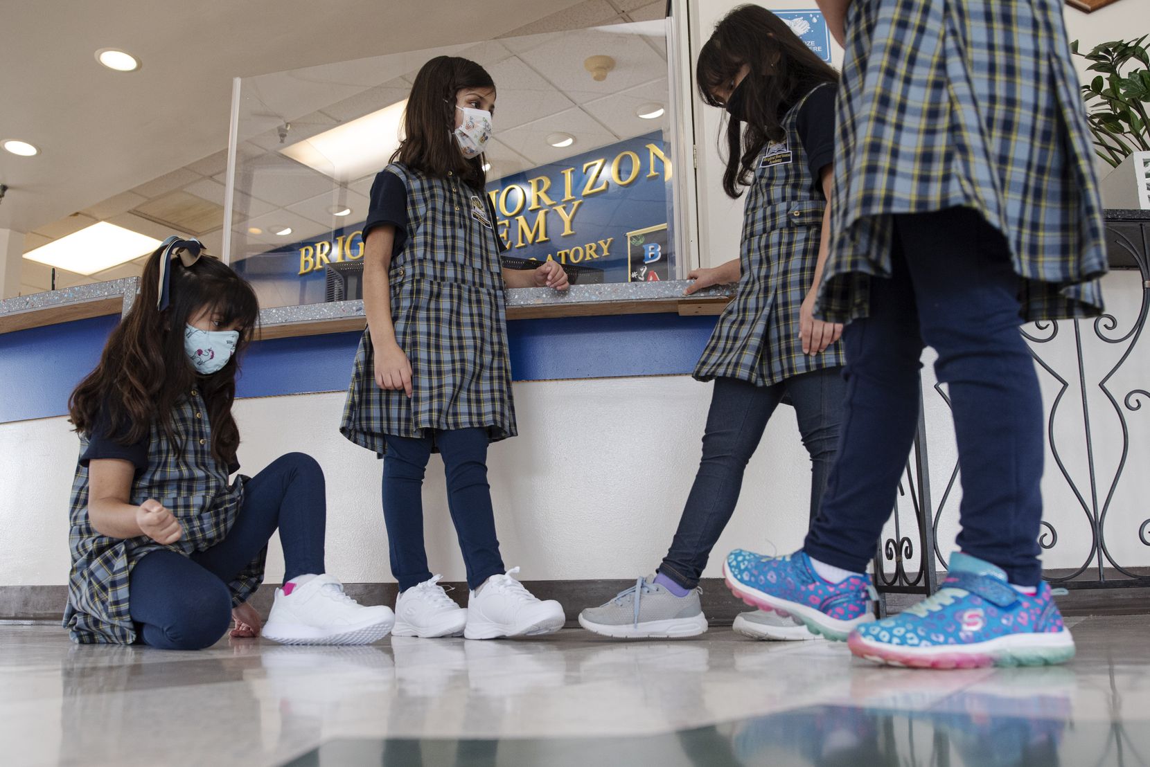 Students Sarah Kadiwala (from left), Mishaal Umar, Hajra Hashmi and Aisha Sheikh mingle in their new uniforms.