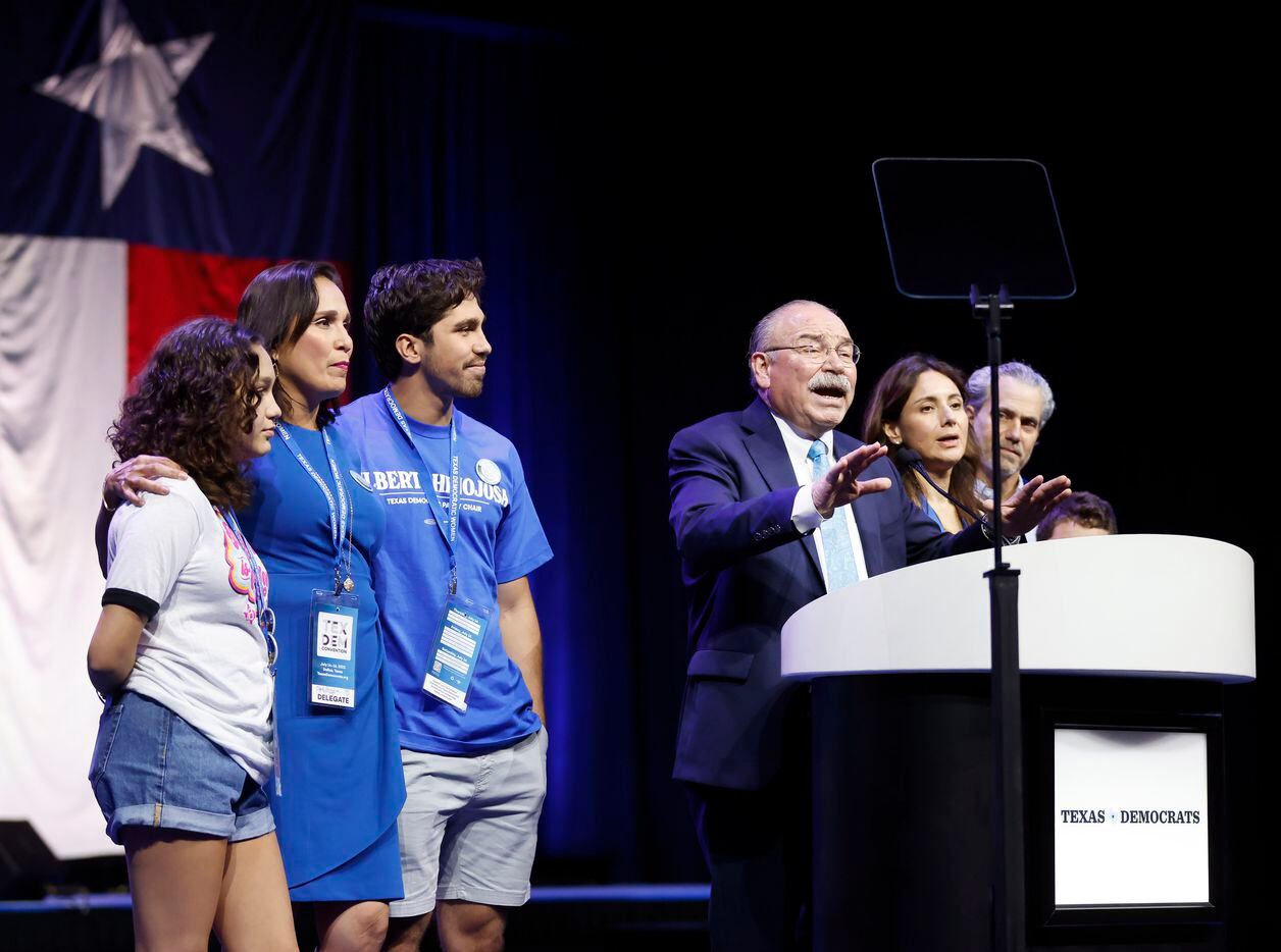 Gilberto Hinojosa (at podium) was surrounded by his family after retaining his position as...
