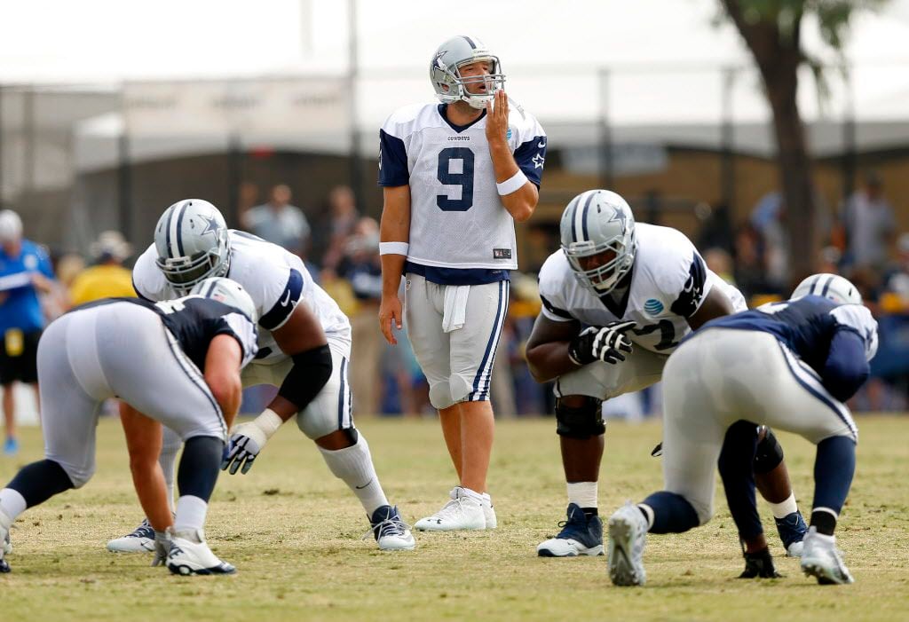 Dallas Cowboys quarterback Tony Romo (9) signals to his receivers during a play in the...