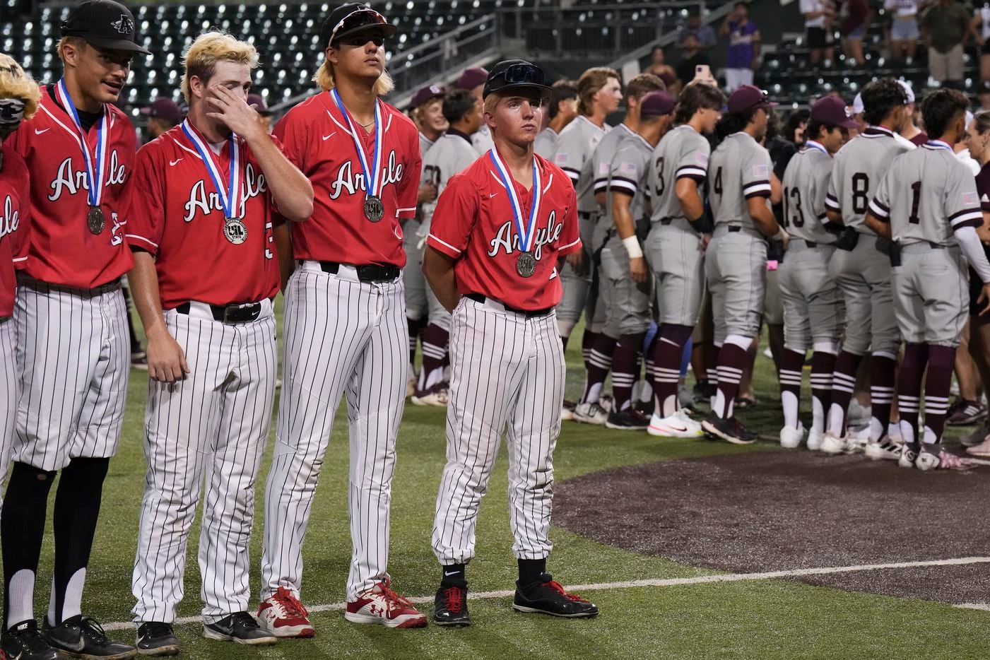 Argyle players Trevor Duck (13), Park Prater (7), and JC Davis (4) stand wearing their...