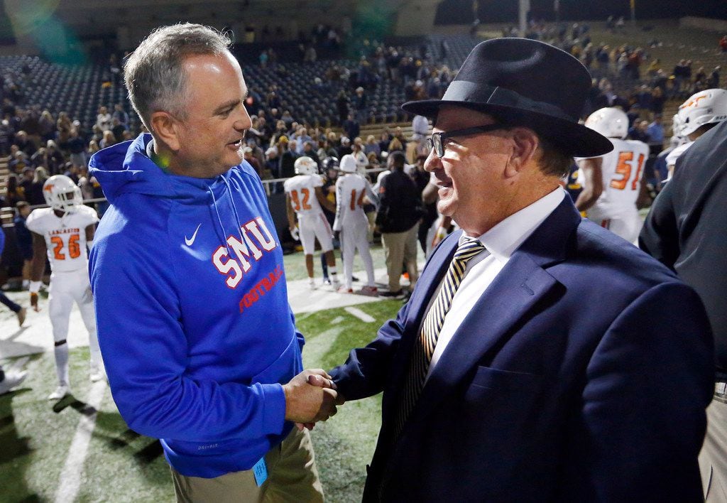 Highland Park head football coach Randy Allen (right) is congratulated on his win by SMU...