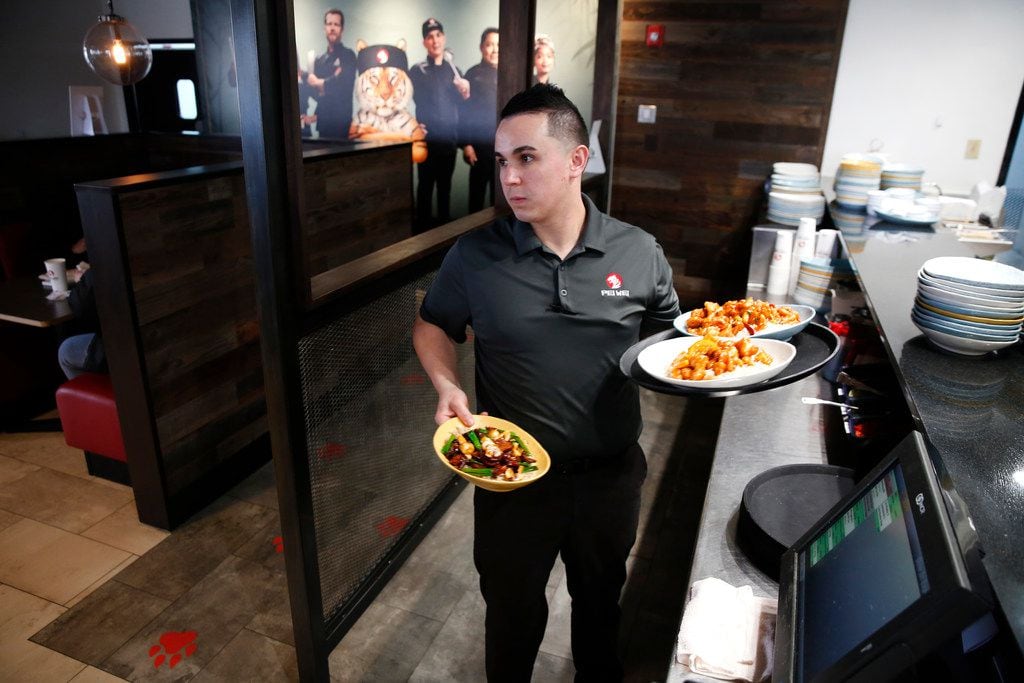 Felipe Morais, general manager, delivers orders at Pei Wei in Irving.