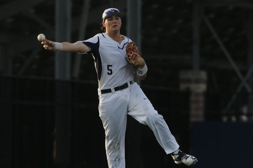 Dallas Jesuit Nic Ready throws out a runner in the first during of the Class 6A Region II...