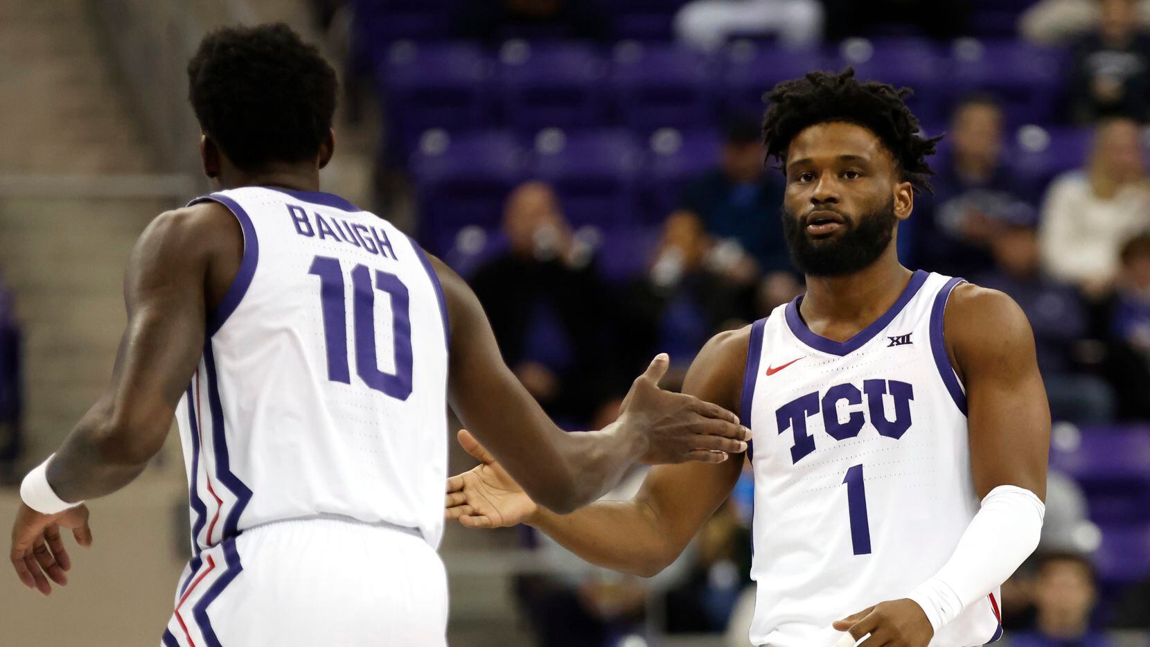 TCU guards Damion Baugh (10) and Mike Miles Jr. (1) celebrate after a basket against...