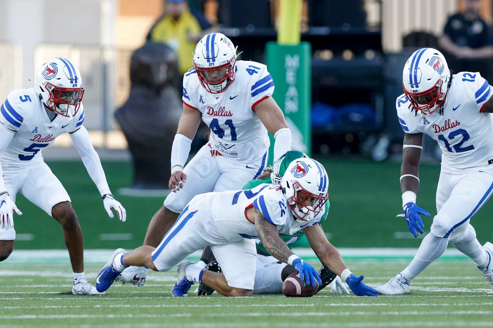 SMU safety Nick Roberts (22) recovers a fumble by UNT wide receiver Roderic Burns (14)...