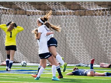 A Boerne Champion defender (right) is left on the ground as Highland Park midfielder Frances...