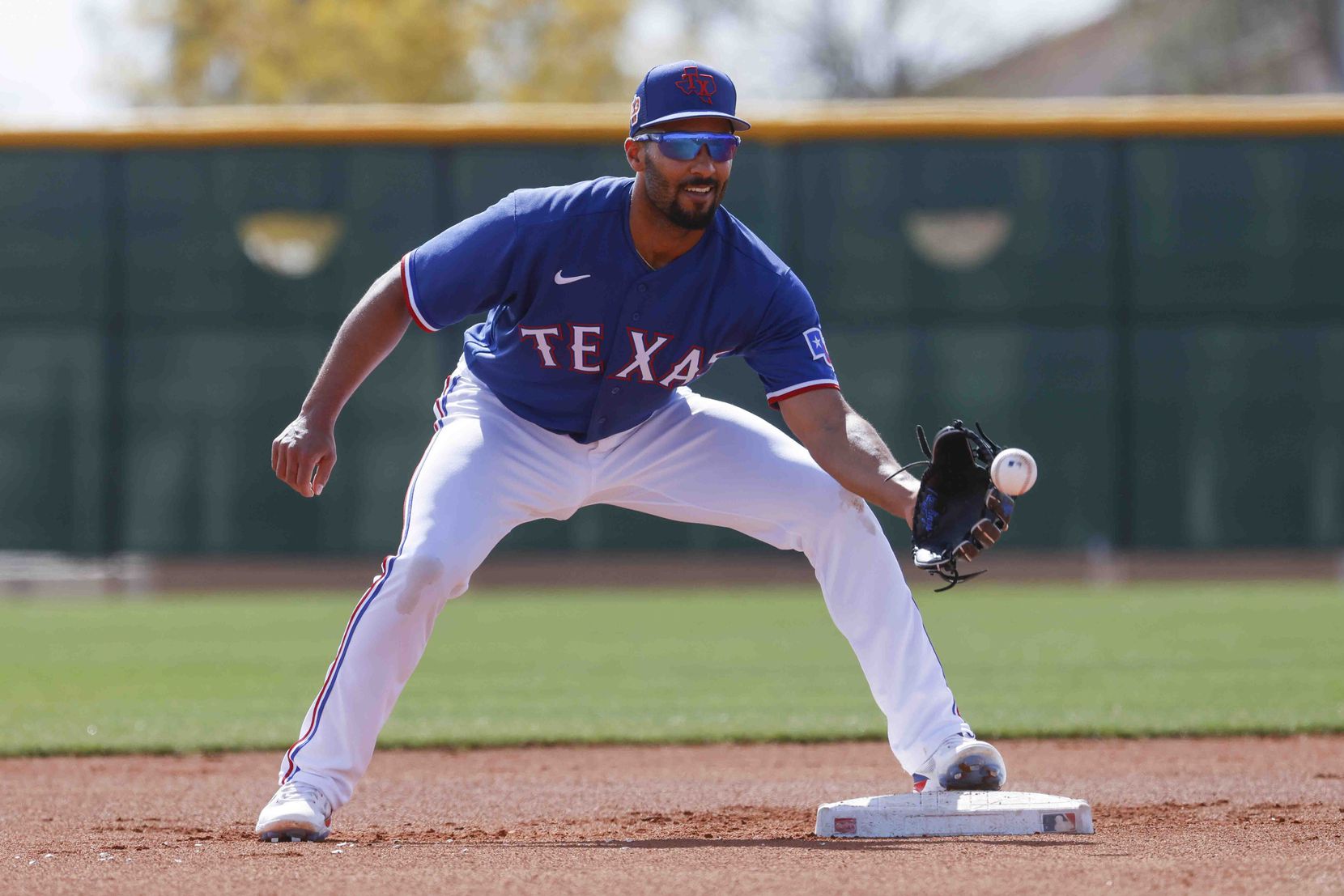 Texas Rangers infielder Marcus Semien makes a catch during a spring training workout at the...