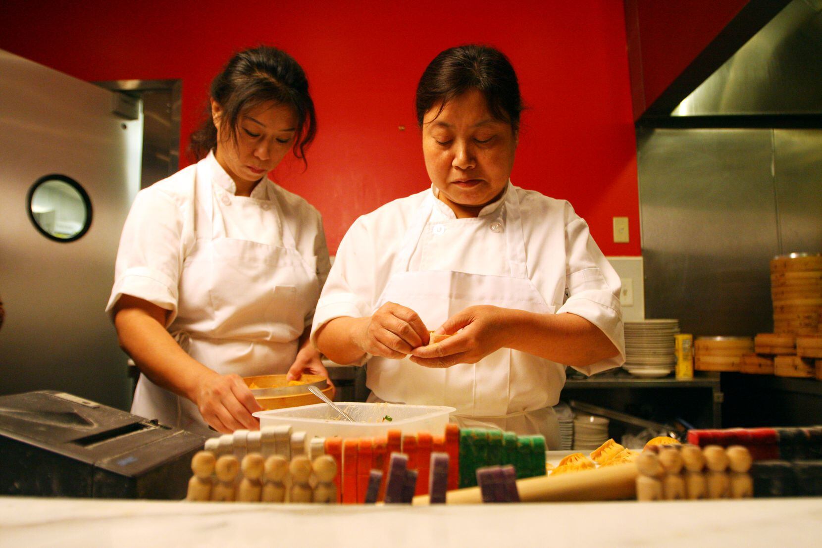 "Dumpling lady" Hwa-Juan Shen, right, in 2012. Shen's husband, Wei-Gu Cai, took over as chef...