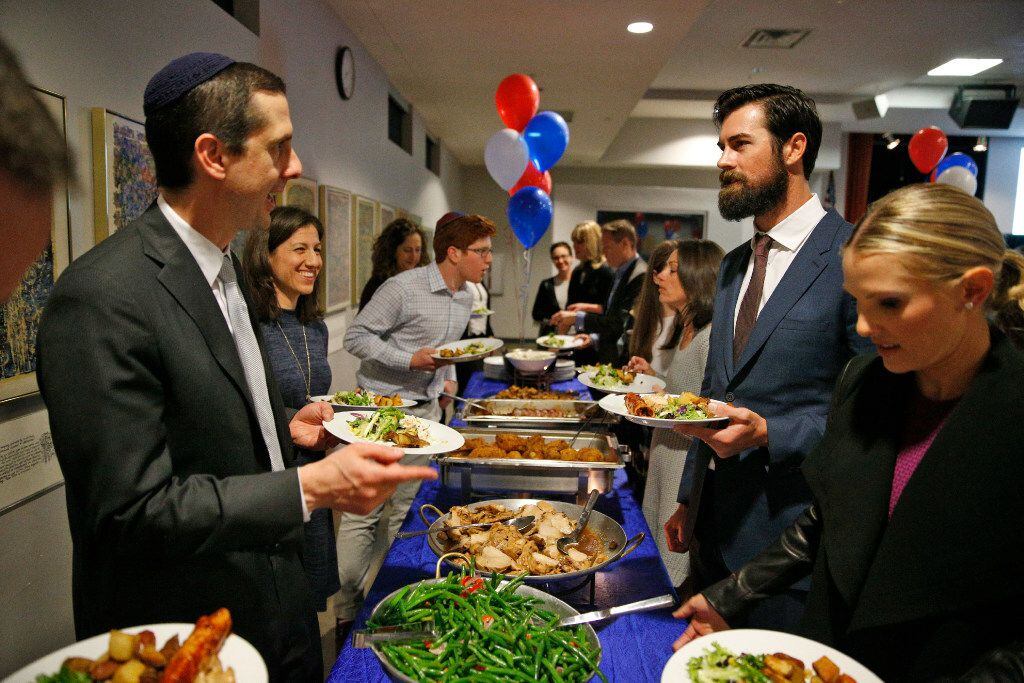 Texas Rangers pitcher Cole Hamels and wife Heidi (right) talk to Neil Rubinstein (left) ,...