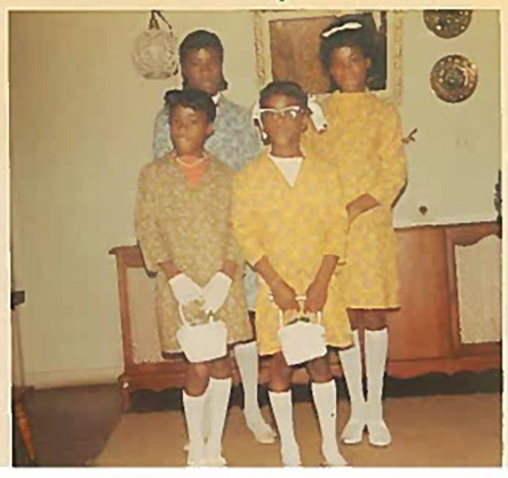 A 6-year-old Cynt (front left) is shown with her three sisters dressed up for Easter in...