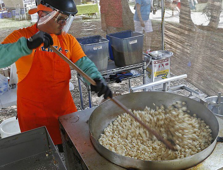 A vendor stirs popcorn during Rockwall Founder's Day Festival. 