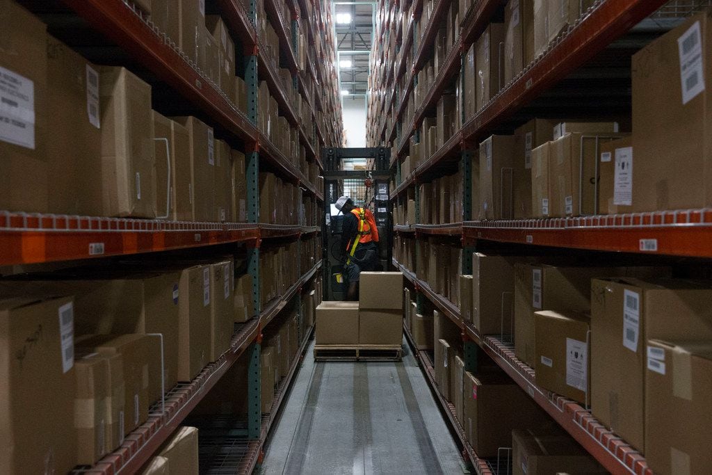 Forklift driver Gerry Giddings looks for an item at the Liquidity Services warehouse in...