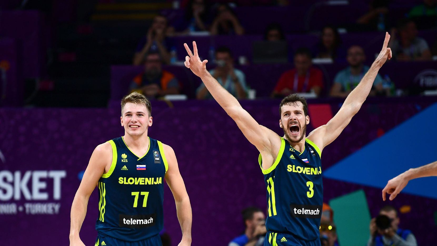 Slovenia's guard Luka Doncic (C) and Goran Dragic (R) celebrate after scoring during the...