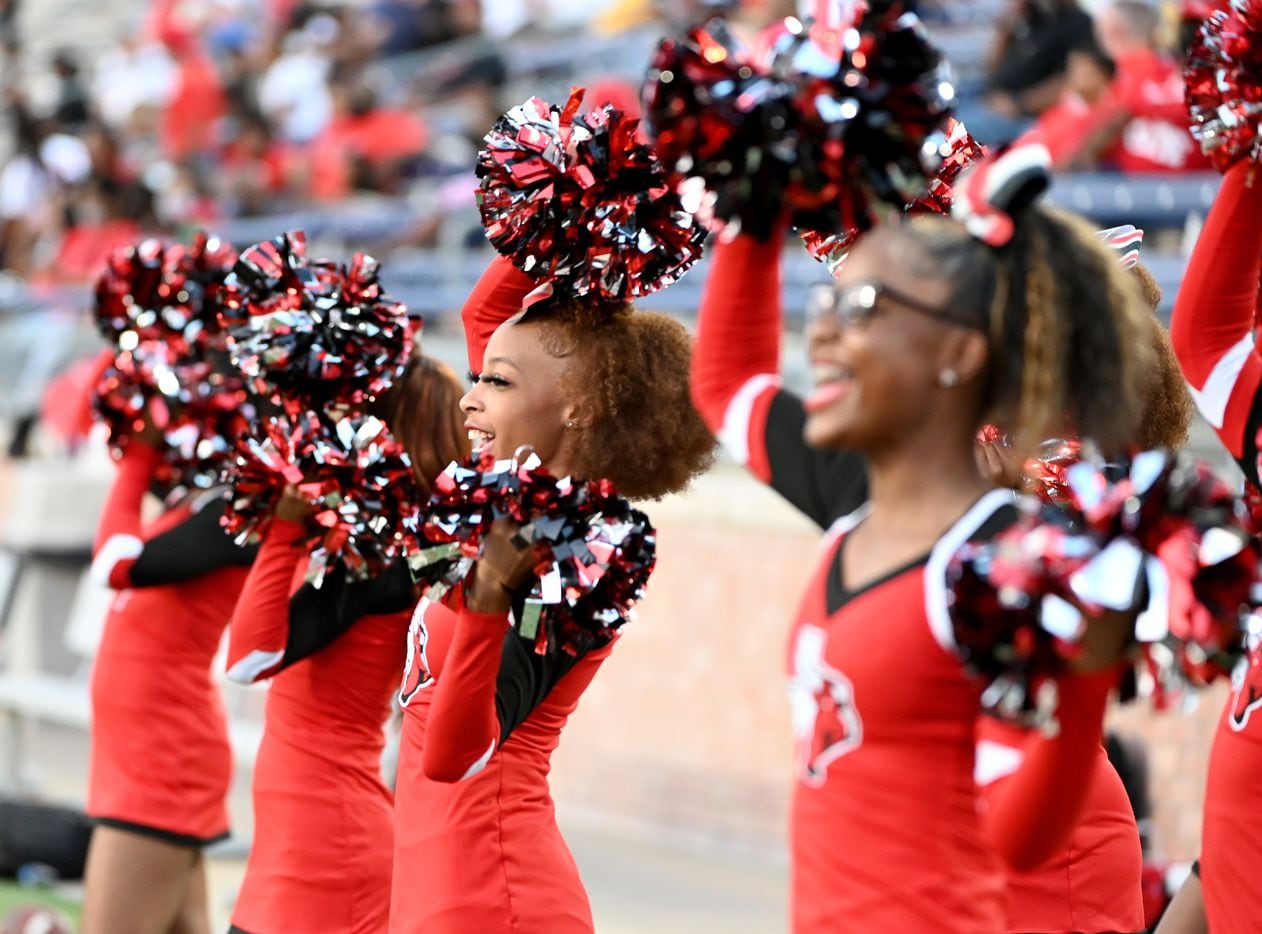 Cedar Hill cheerleaders perform in the first half of a high school football game between...