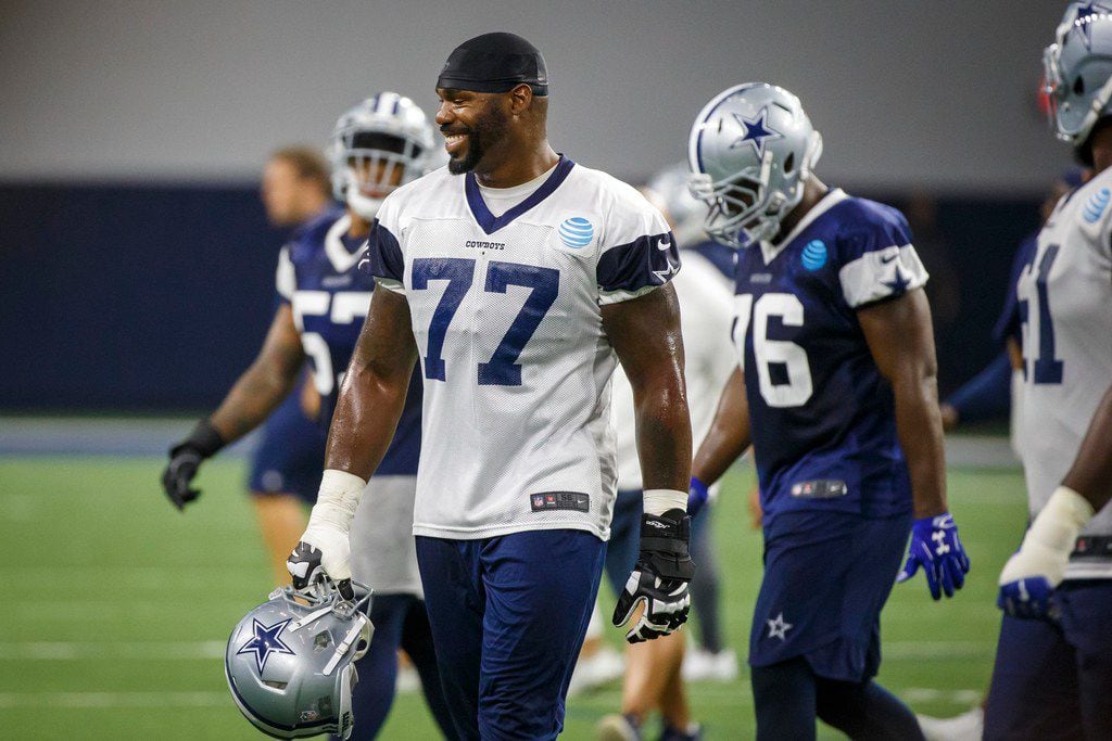 Dallas Cowboys offensive tackle Tyron Smith (77) walks between drills during the team's ...