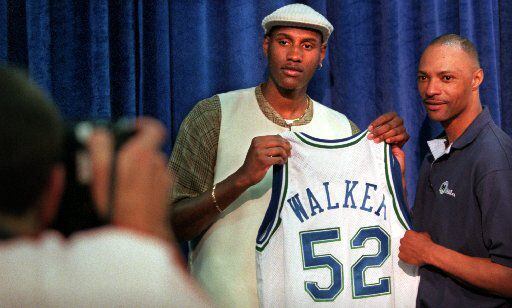 6/27/96--Dallas first-round draft pick  Samaki (cq) Walker poses for a photo with his new...