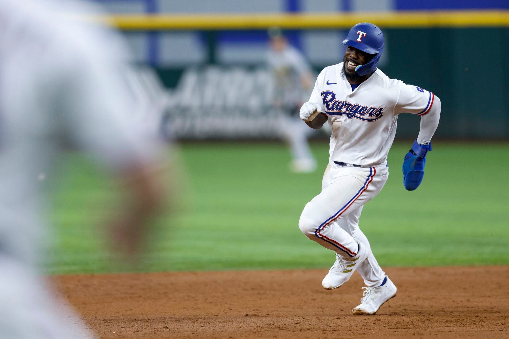 Texas Rangers right fielder Adolis Garcia (53) rounds second base after a hit by first...