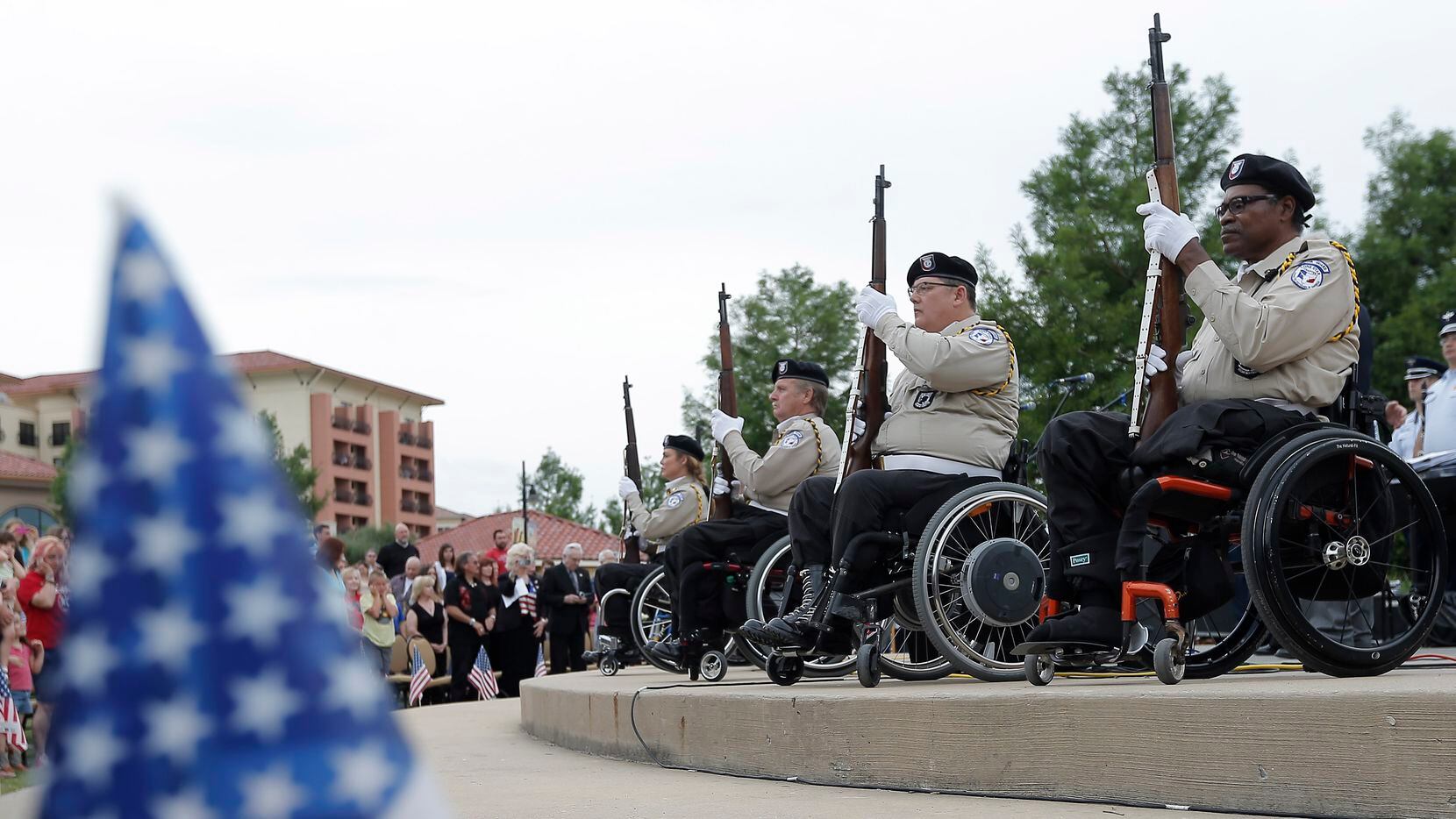 Members of the Paralyzed Veterans of America, Lone Star Chapter, Honor Guard hold their...