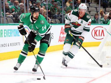 Dallas Stars left wing Jamie Benn (14) is pursued by Minnesota Wild defenseman Ryan Suter (20) in the first period during an NHL hockey game Friday, Feb. 7, 2020 in Dallas.