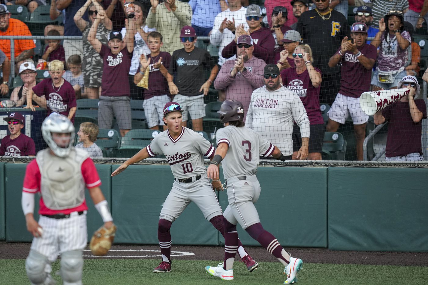 Sinton shortstop Blake Mitchell (3) celebrates with outfielder Kline Chester (10) after...