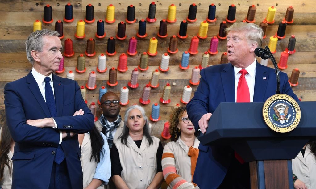President Donald Trump, flanked by the chairman and CEO of LVMH, Bernard Arnault, speaks...